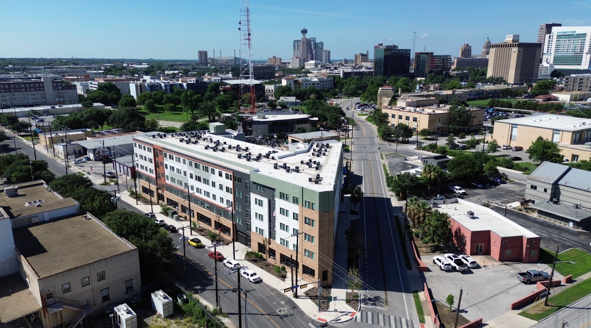 Aerial view of Museum Reach Lofts with downtown San Antonio skyline