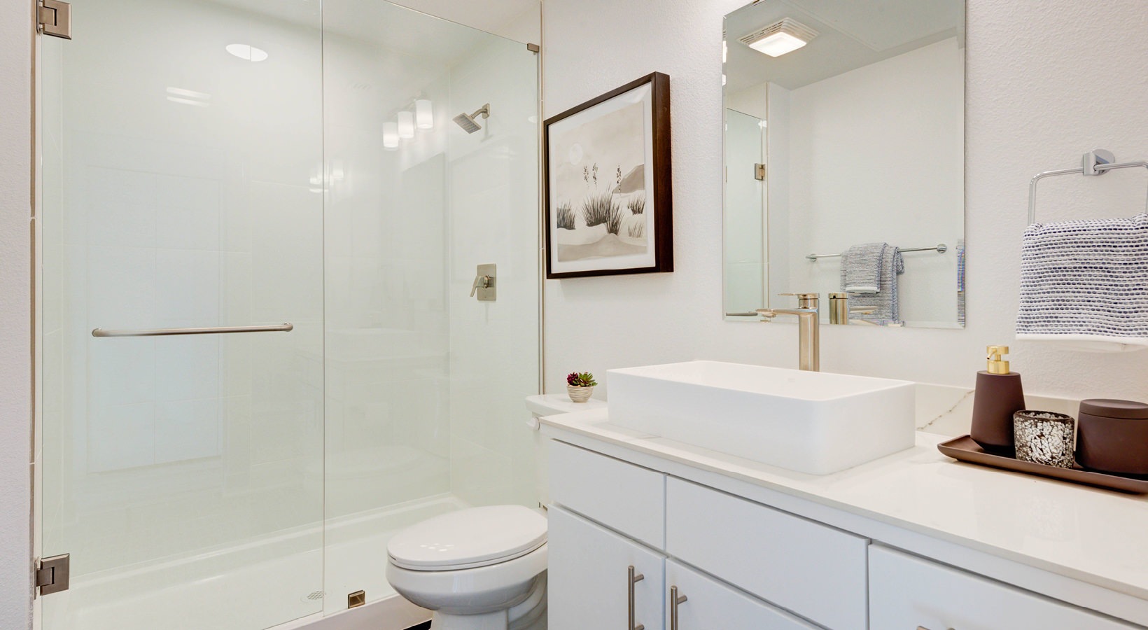 Renovated bathroom with glass shower and modern vanity