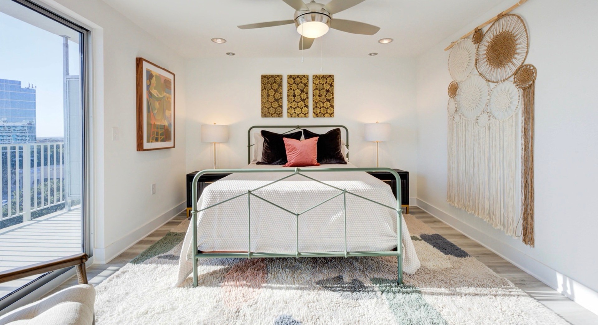 Staged bedroom with balcony access and bohemian decor