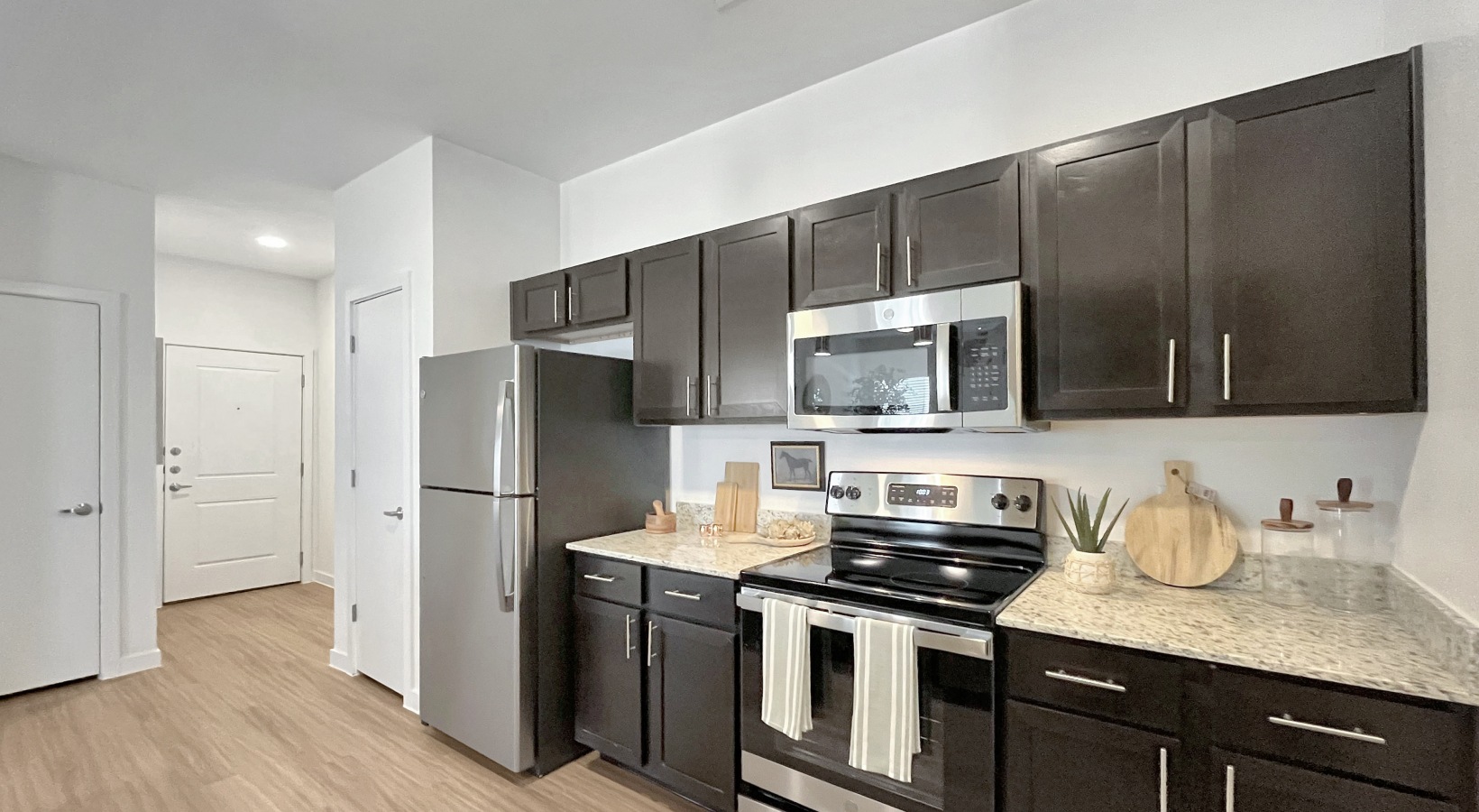 Kitchen with dark cabinetry and stainless appliances