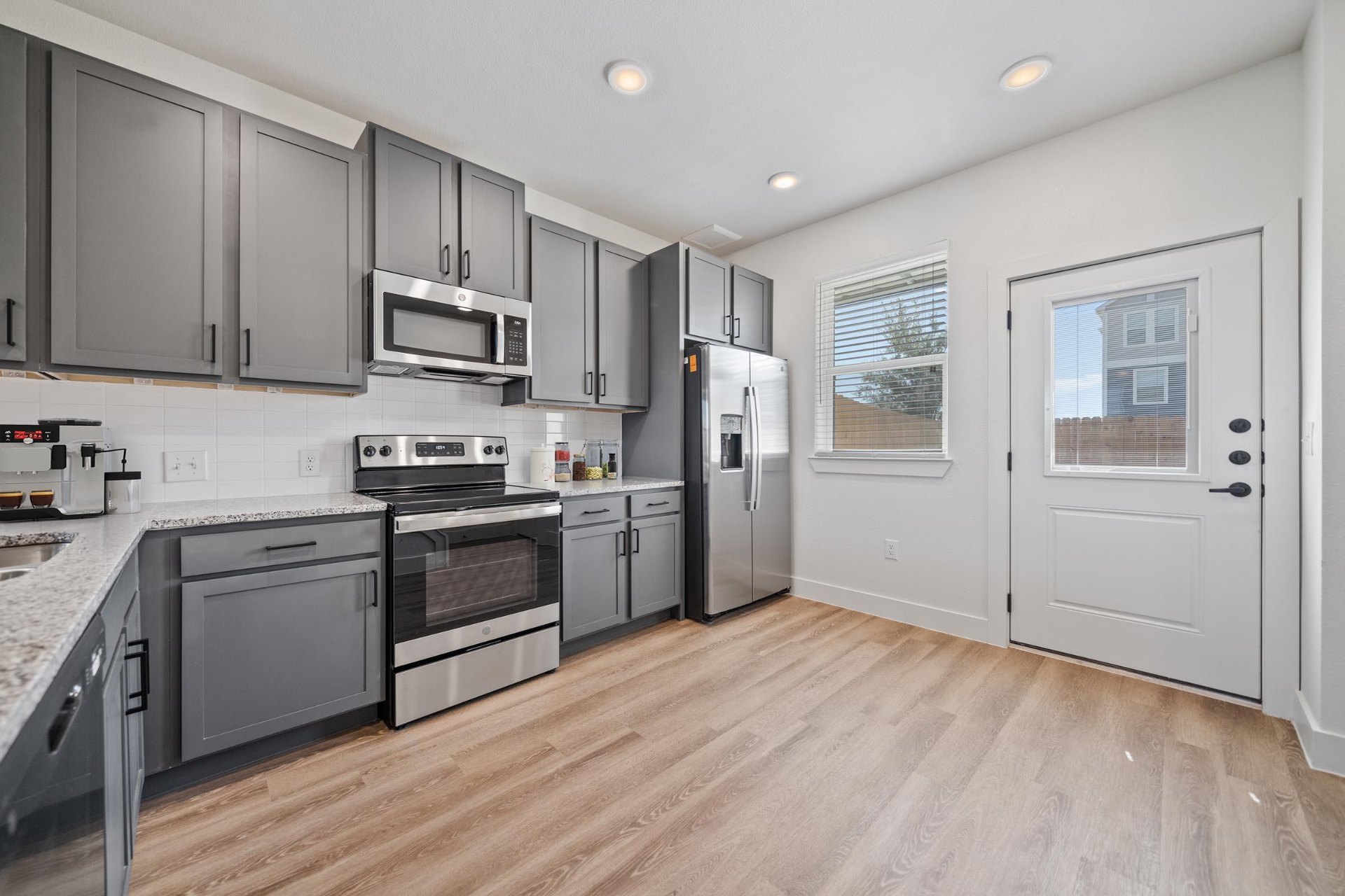 Kitchen with gray cabinets and stainless appliances