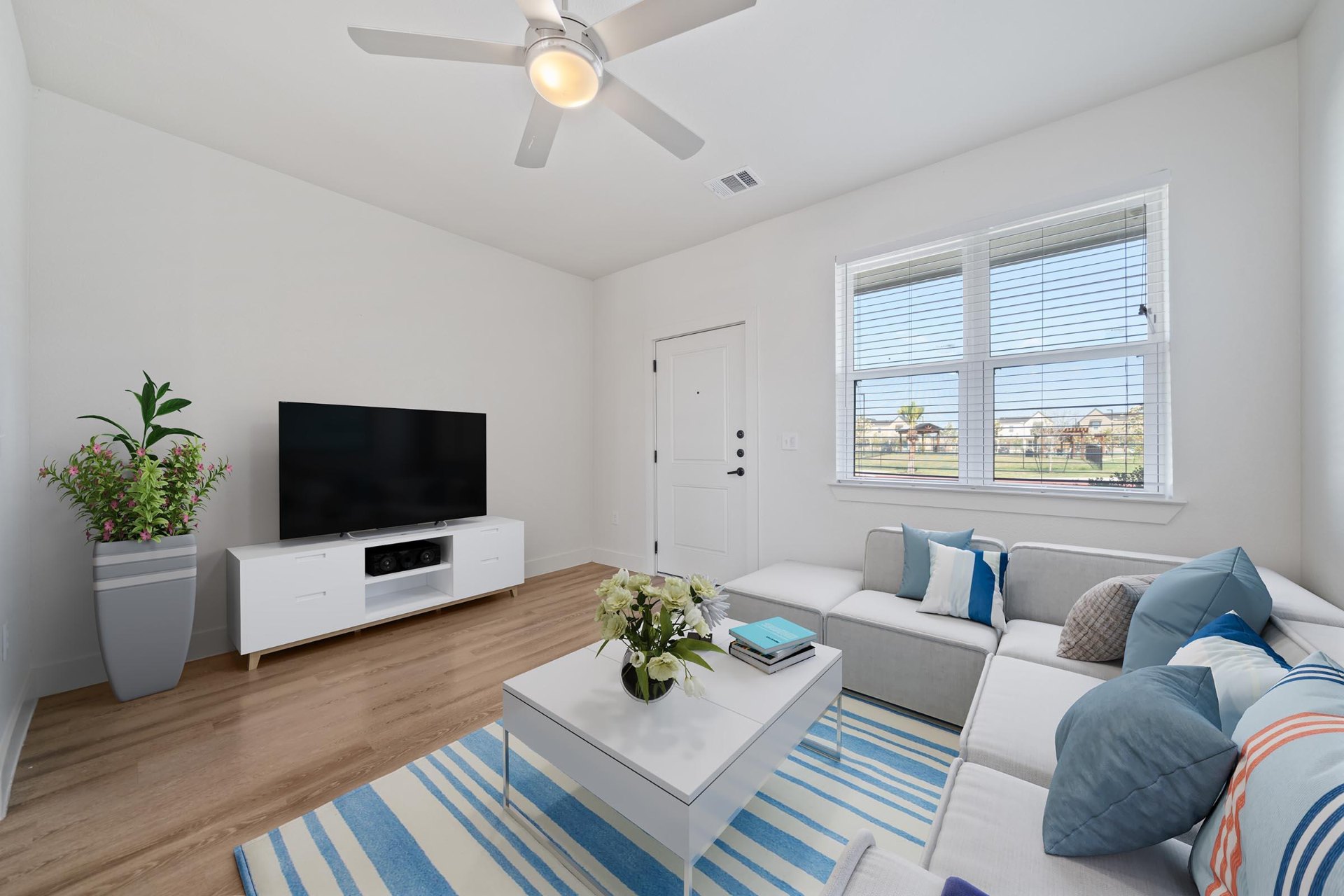 Open living room with sectional and entry