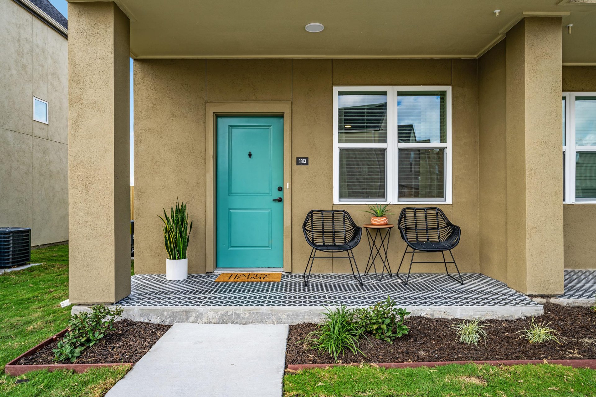 Townhome front porch with teal door